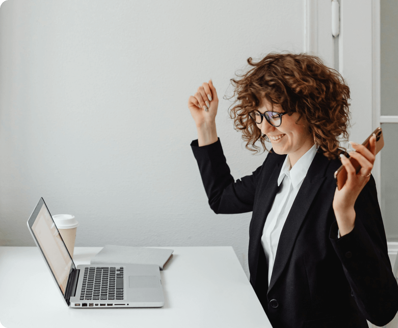 girl smiling in front of a laptop
